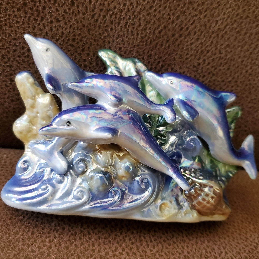 Iridescent glazed porcelain dolphin figurine